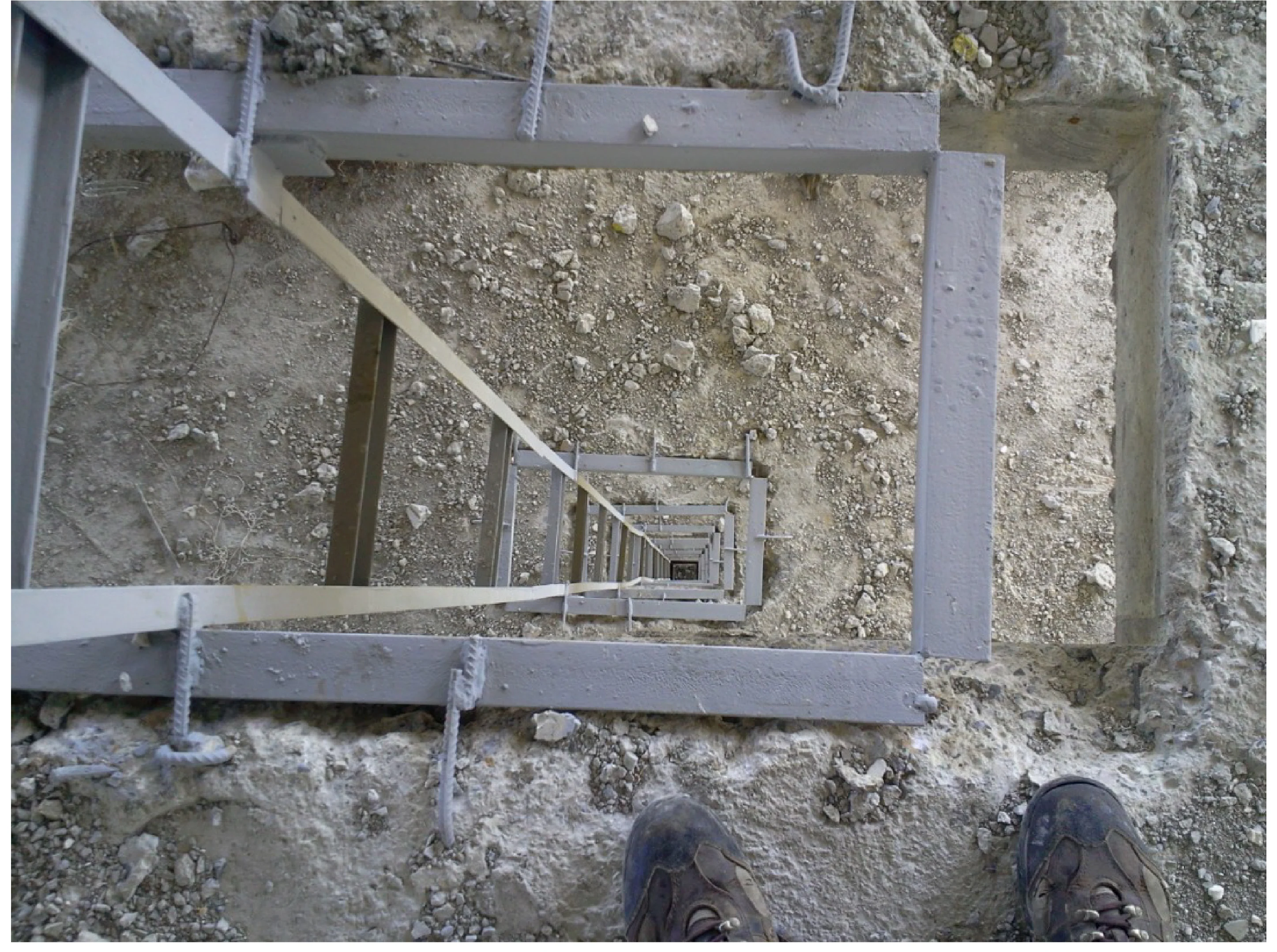 Unit waste pipes routed through secondary ducts on a steel ladder structure.